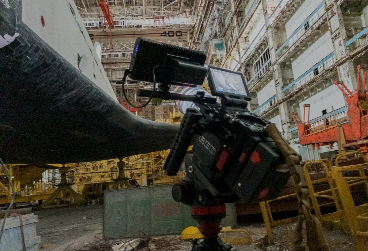Cinema camera rig inside an industrial spacecraft facility